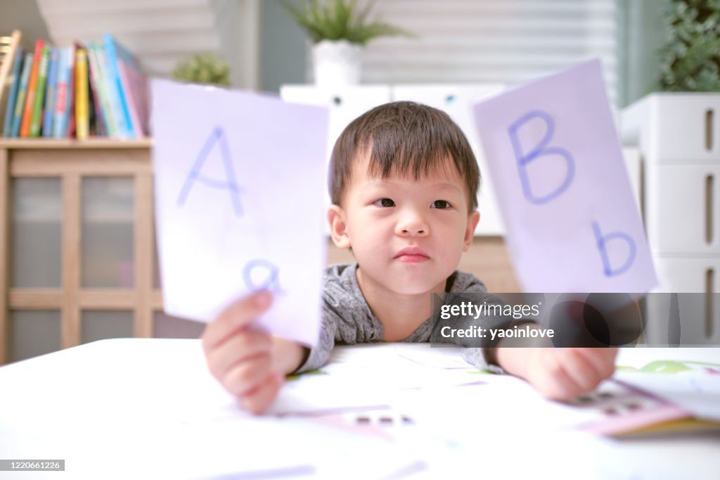 Niños asiáticos aprendiendo inglés con tarjetas flash, Enseñar inglés a los niños pequeños en casa, Niño en casa, jardín de infantes cerrado durante la crisis de salud de Covid-19