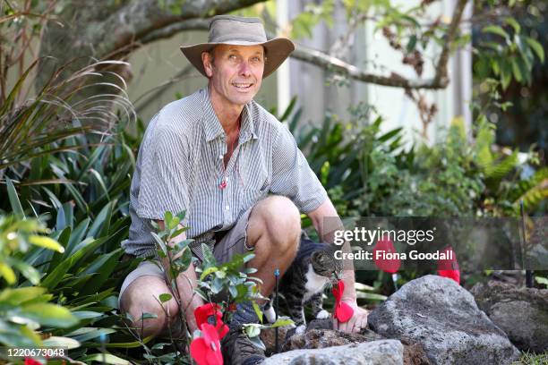 Bruce Inwood and his cat Poppy prepare an Anzac tribute in the garden in Titirangi on April 24, 2020 in Auckland, New Zealand. New Zealanders are...