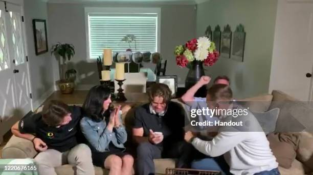 In this still image from video provided by the NFL, Justin Herbert holds his phone during the first round of the 2020 NFL Draft on April 23, 2020.