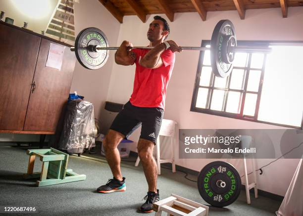 Goalkeeper of Argentina National Hockey team Juan Manuel Vivaldi lifts weights as he trains in isolation during the government-ordered lockdown at...