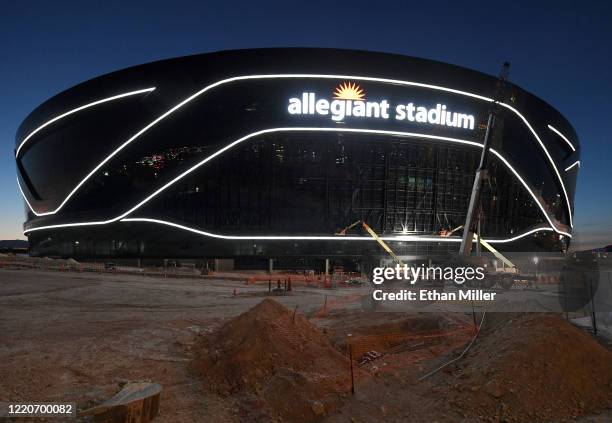 Crews test out architectural light ribbons and exterior sign lighting as construction continues at Allegiant Stadium, the USD 2 billion, glass-domed...