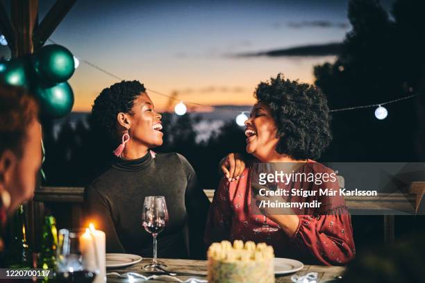 cheerful female friends enjoying wine at birthday - woman birthday stock pictures, royalty-free photos & images