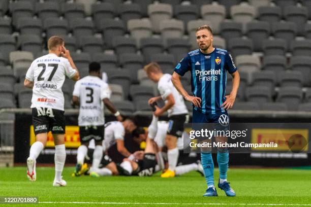 Jonathan Ring of Djurgardens IF is dejected as players from Orebro SK celebrate their 2-1 goal with during an Allsvenskan match between Djurgardens...