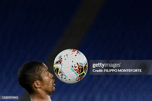 Juventus' Brazilian forward Douglas Costa eyes the ball during the TIM Italian Cup final football match Napoli vs Juventus on June 17, 2020 at the...