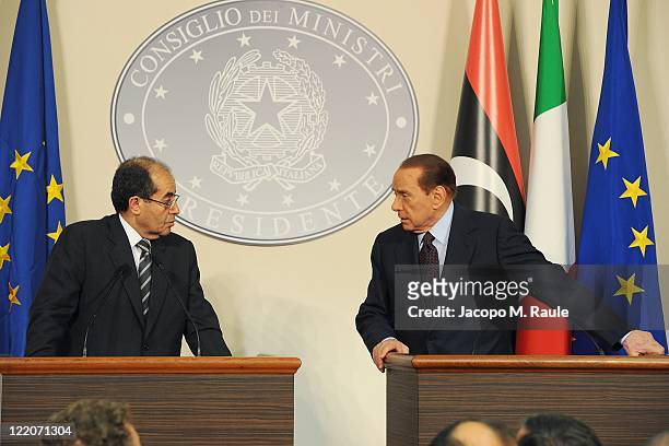 Deputy chairman of the National Transitional Council Executive Board Mahmoud Jibril speaks with Italian Prime Minister Silvio Berlusconi during their...