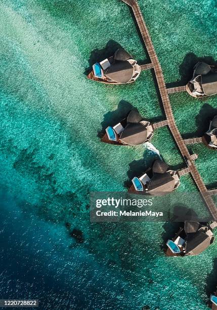 maldives island lagoon with water villas - private island stock pictures, royalty-free photos & images