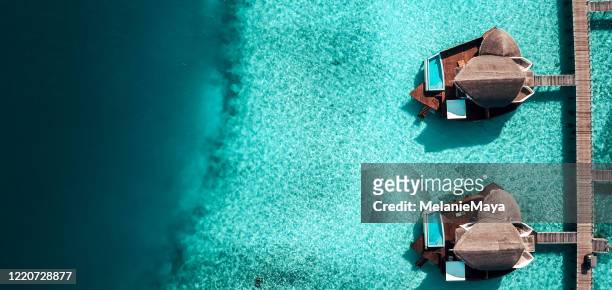 maldives island resort over water villas - drone point of view beach stock pictures, royalty-free photos & images