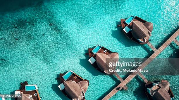 malediven island resort over water villas - luxury hotel island stock-fotos und bilder