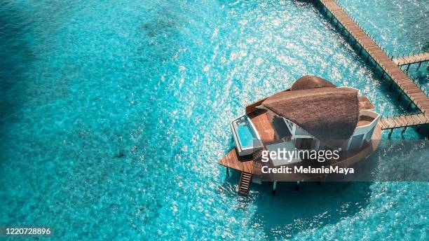 maldives island resort over water villas - maldives boat stock pictures, royalty-free photos & images
