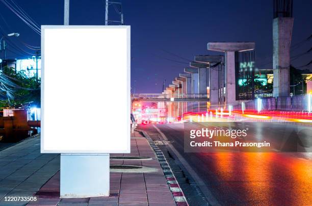 blank billboard on city street at night. outdoor advertising - bus advertising stockfoto's en -beelden