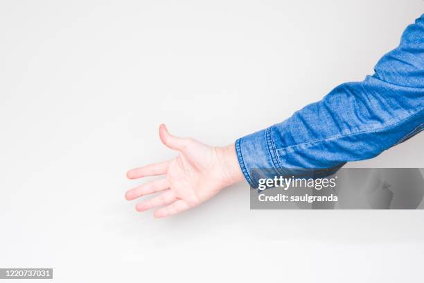 man's hand on light background - denim shirt stock pictures, royalty-free photos & images