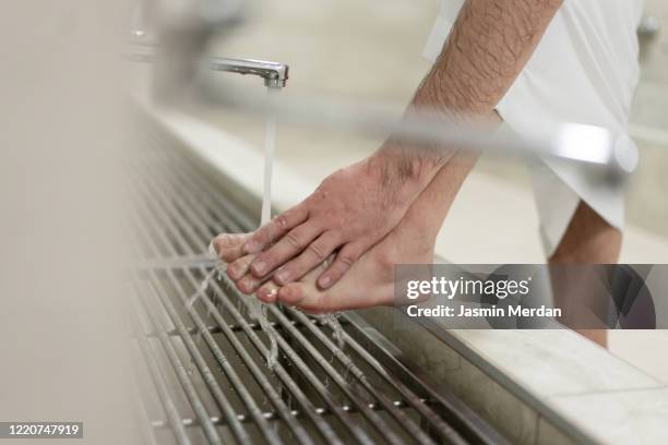 muslim man taking ablution for prayer washing foot - foot worship 個照片及圖片檔
