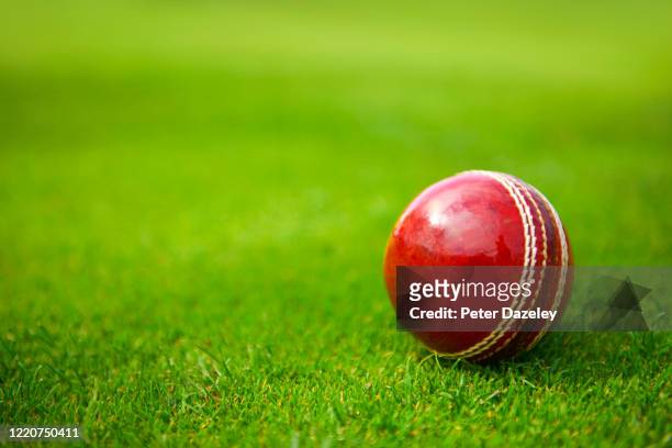 In this photo illustration, a Cricket Ball lies on grass on April 24,2020 in Surrey, England.