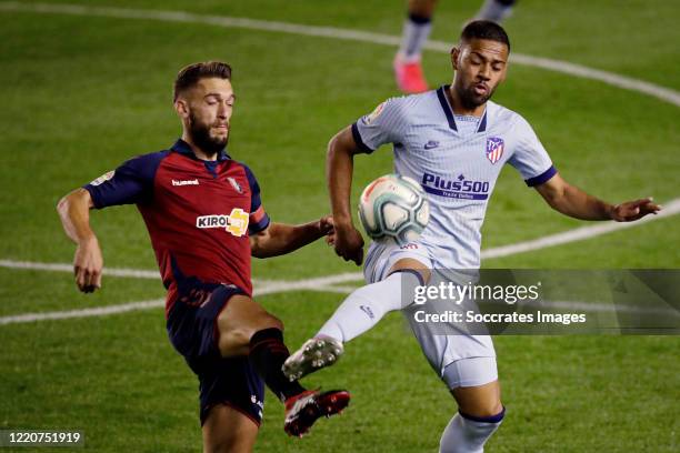 Enrique Barja of Osasuna, Renan Lodi of Atletico Madrid during the La Liga Santander match between Osasuna v Atletico Madrid at the El Sadar stadium...