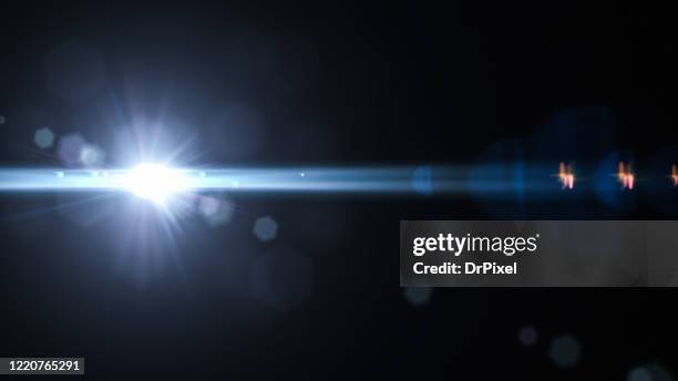 lens flare on black background - lumiere photos et images de collection