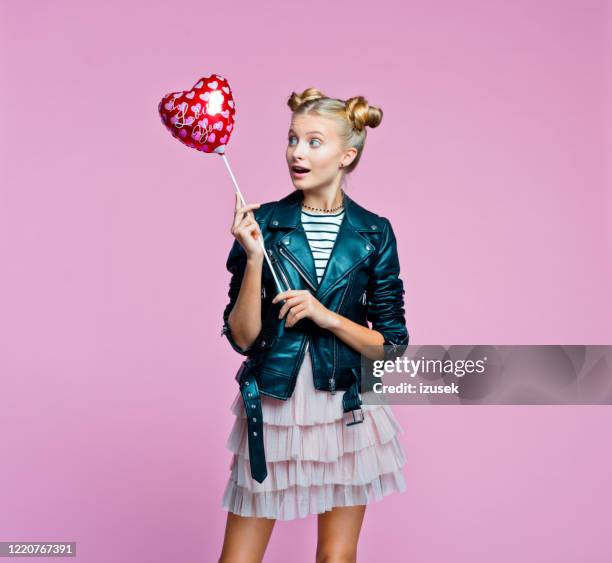 fille élégante de teenege retenant le ballon en forme de coeur - child balloon studio photos et images de collection
