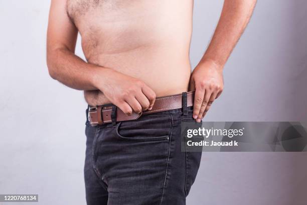 mid section of a shirtless man with a fat belly and wearing a black jean - overweight - hairy fat man stock pictures, royalty-free photos & images