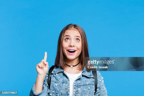 happy teenge girl pointing with finger at copy space - oversized necklace stock pictures, royalty-free photos & images