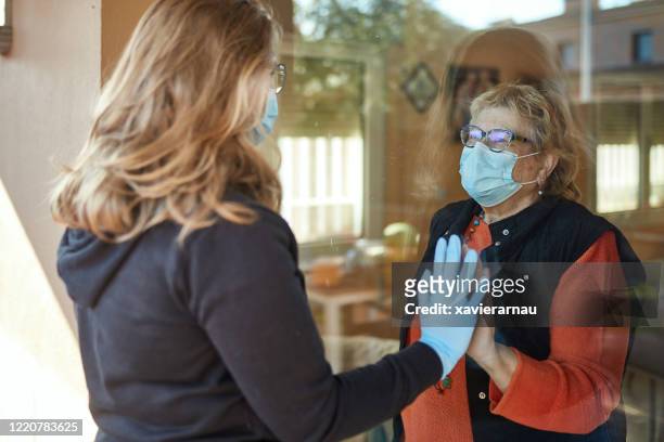 enkelin besucht großmutter während pandemie - visit stock-fotos und bilder