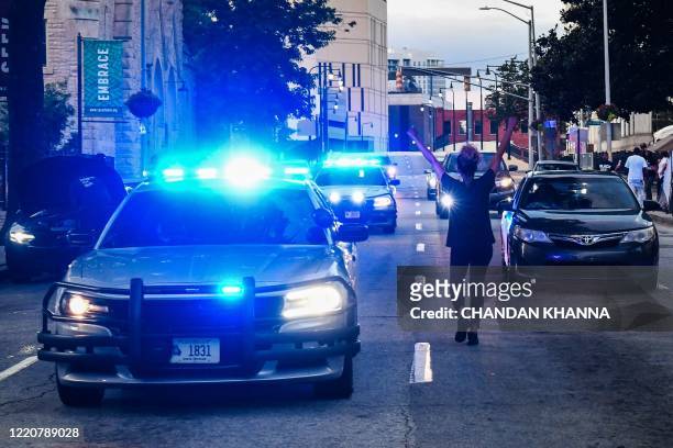 Protestor blocks the traffic outside Georgia State Capitol during a protest on the fifth day following Rayshard Brooks death by police in a...