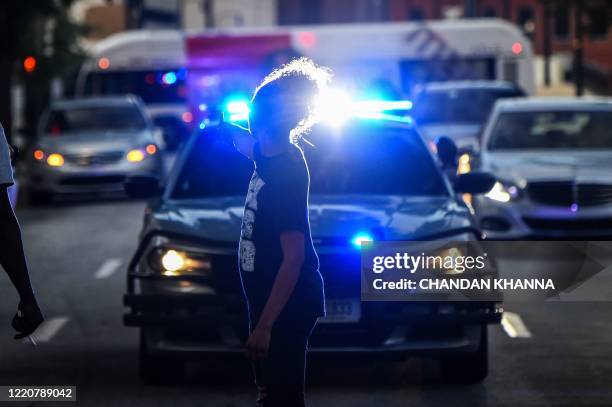 Protestor blocks the traffic outside Georgia State Capitol during a protest on the fifth day following Rayshard Brooks death by police in a...