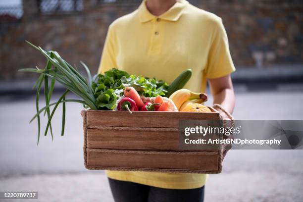 woman delivering vegetables and fruits to home - convenience basket stock pictures, royalty-free photos & images