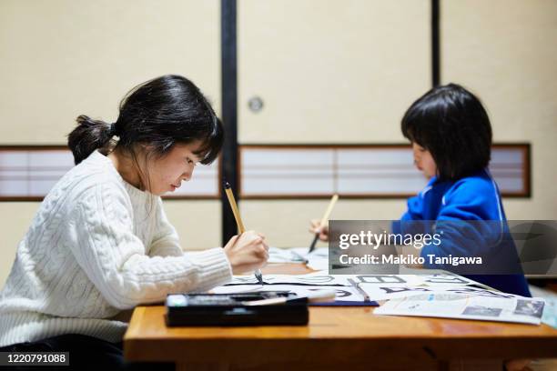 japanese girls doing kakizome - japanese calligraphy stock pictures, royalty-free photos & images