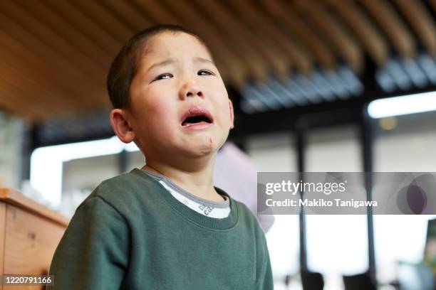 closeup of japanese boy crying - serious injury stock pictures, royalty-free photos & images