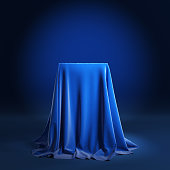 Empty podium covered with blue cloth.