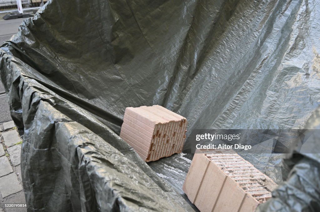 Several bricks in a container, protected with a plastic tarp. Berlin. Germany.