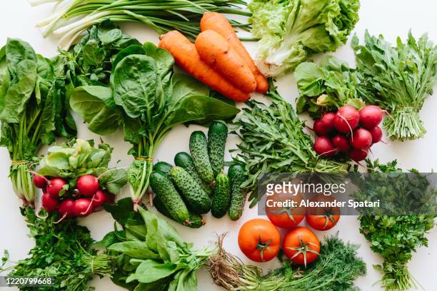 fresh greens and vegetables on a table, high angle view - leaf vegetable stock pictures, royalty-free photos & images