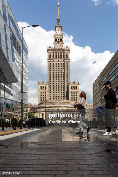 Passers by are seen walking in front of Culture and Science Palace, a landmarks of Polish capital - Warsaw, Poland on June 17, 2020.