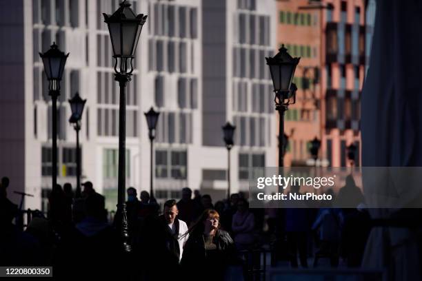 People are seen in the city center with modern buildings resembling the old, Mannerist architecture of the pre-war city on May 31, 2020 in Gdansk,...