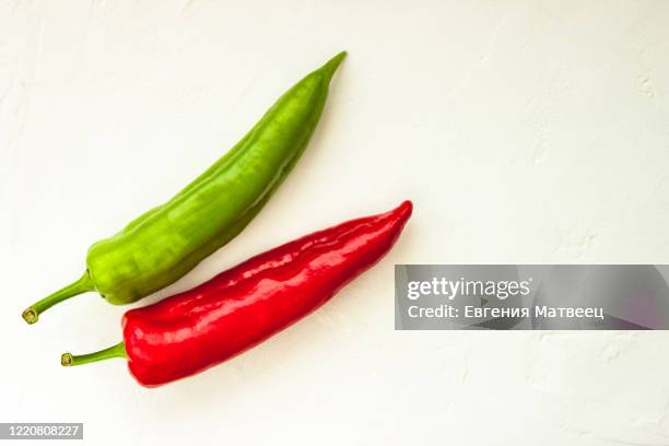 red, green cayenne hot chili pepper on white background immune support healthy eating concept - jalapeño stockfoto's en -beelden