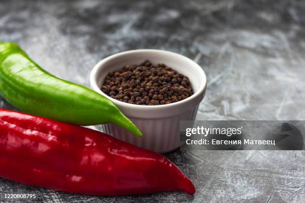 red, green cayenne hot chili pepper on black, white background immune support healthy eating concept - cayenne pepper stock pictures, royalty-free photos & images