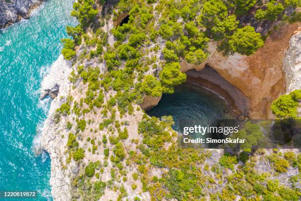 aerial view of a cave with water, gargano national park, puglia, italy - puglia italy stock pictures, royalty-free photos & images