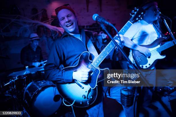 rock band performing in a garage bar - metal guitarist stock pictures, royalty-free photos & images