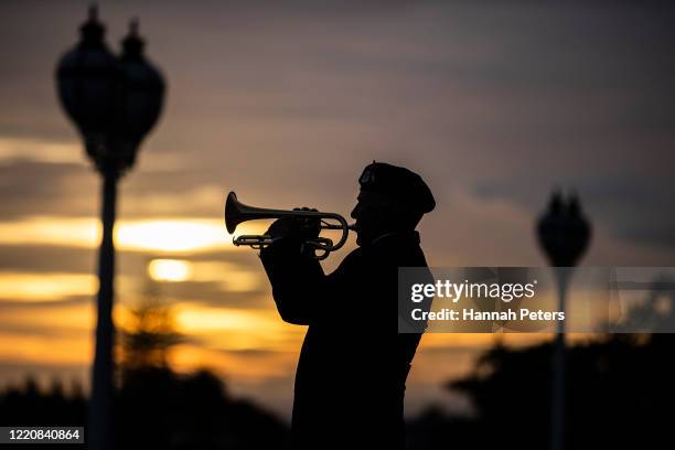 Former soldier plays a bugle outside Auckland museum on April 25, 2020 in Auckland, New Zealand. Traditional Anzac Day ceremonies have been cancelled...