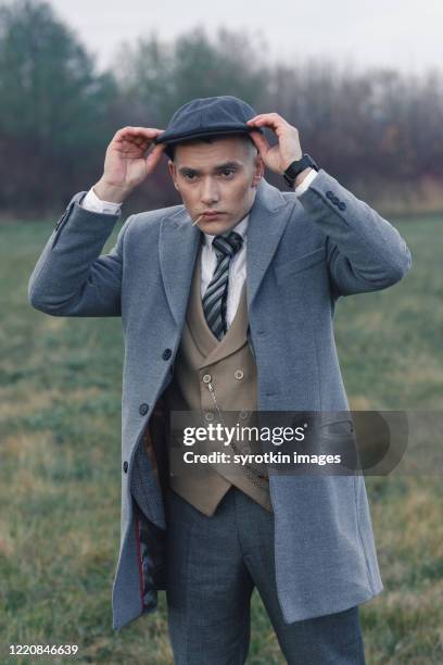 bad boy wearing cap on head. - secret agent suit cutout stock pictures, royalty-free photos & images