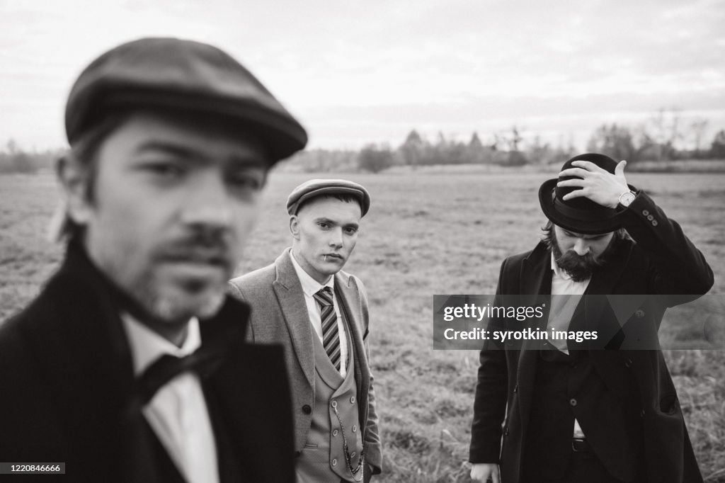 Monochrome of boys posing and looking at camera.