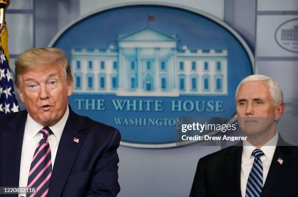 President Donald Trump speaks while flanked by Vice President Mike Pence during the daily coronavirus task force briefing at the White House on April...