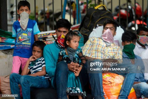 Stranded migrant workers with their belongings wait to board a special train to Bihar state from MGR central railway station after the government...