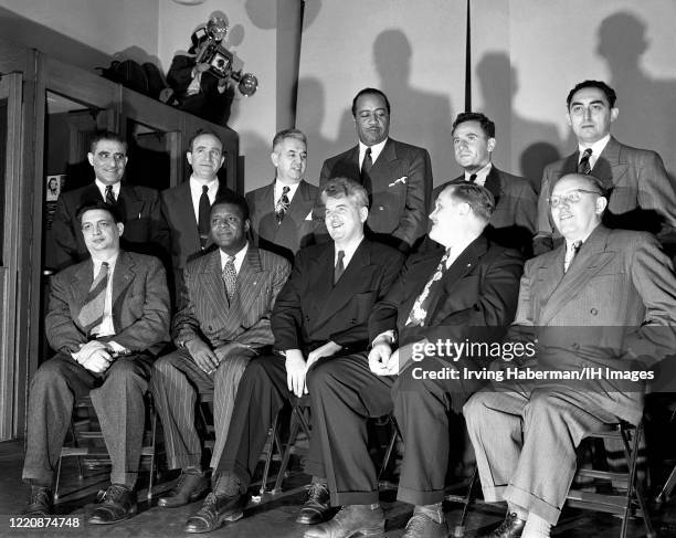 The defendants Jack Stachel, Irving Potash, Carl Winter, Benjamin J. Davis, John Gates, Gil Green. Front row: Robert G. Thompson, Henry Winston,...