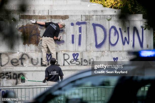City workers clean the vandalized John C. Calhoun Monument in Marion Square on June 18, 2020 in Charleston, South Carolina. After Charleston Mayor...