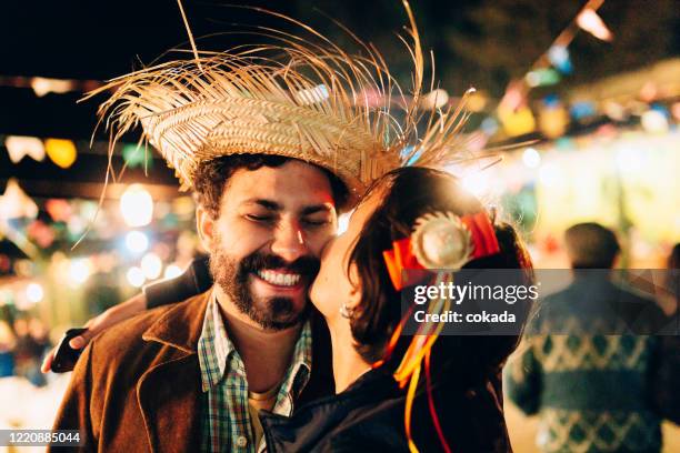 young couple kissing at festa junina - festa junina imagens e fotografias de stock