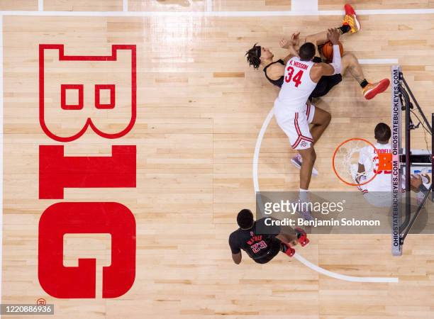Caleb McConnell of the Rutgers Scarlet Knights and Kaleb Wesson of the Ohio State Buckeyes fight for the ball at Value City Arena on February 12,...