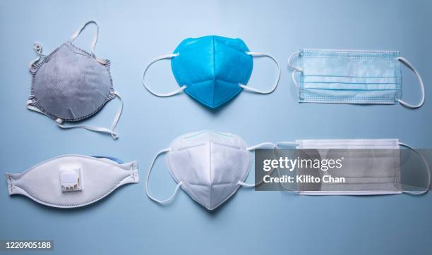 different types of protective face mask against blue background - mascarilla-n95 fotografías e imágenes de stock