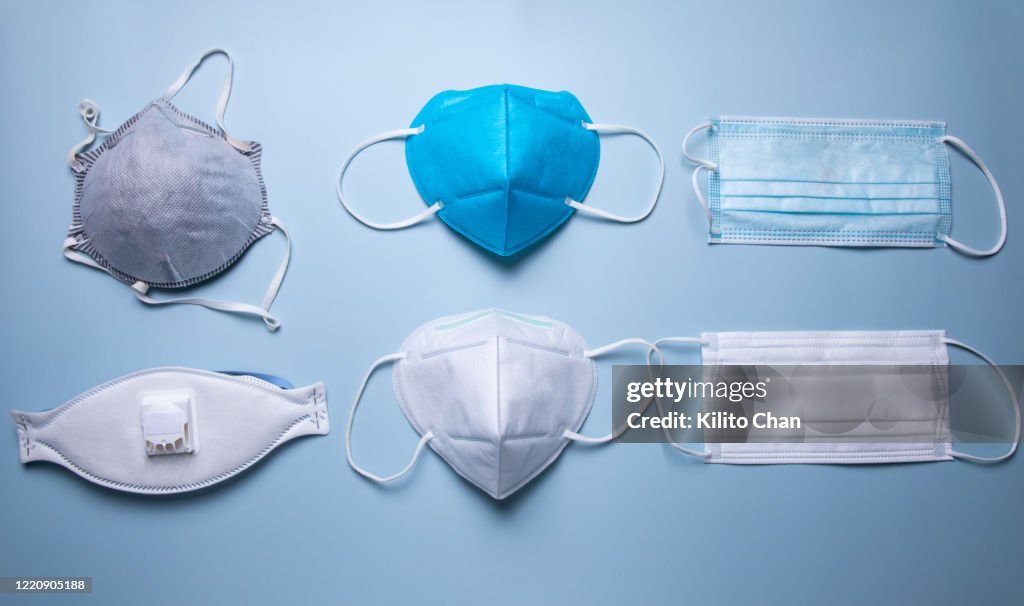 Different types of protective face mask against blue background