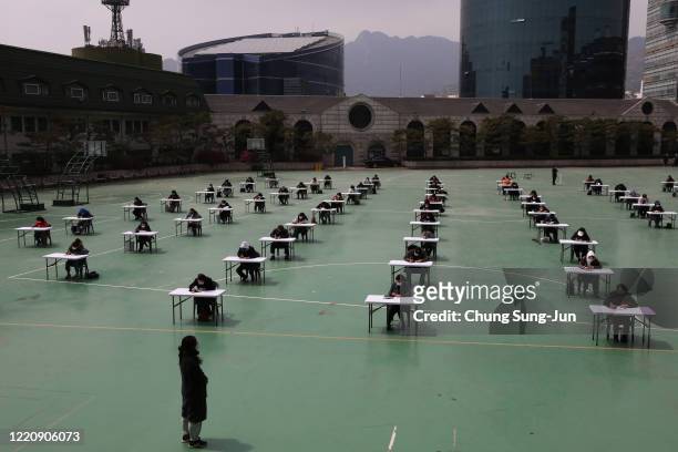 South Koreans wear masks and sit according to social distancing as a preventive measure against the coronavirus , as they prepare for an insurance...