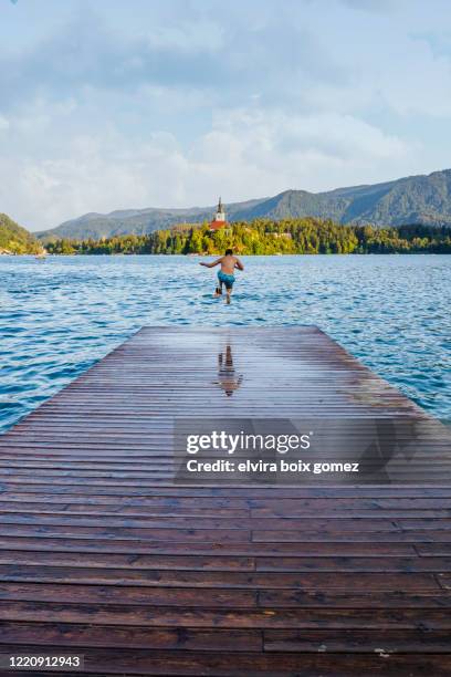 jumping in lake bled - slovenia beach stock pictures, royalty-free photos & images